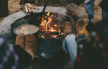 a group of people sitting around a campfire