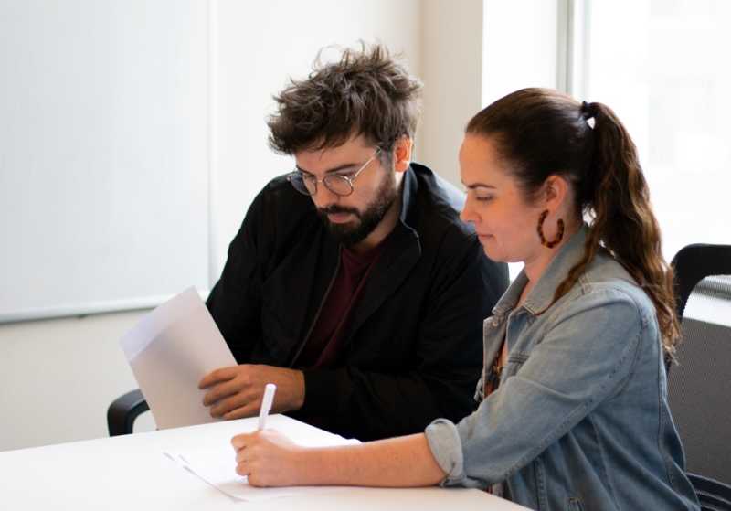 Two employees working together at a table