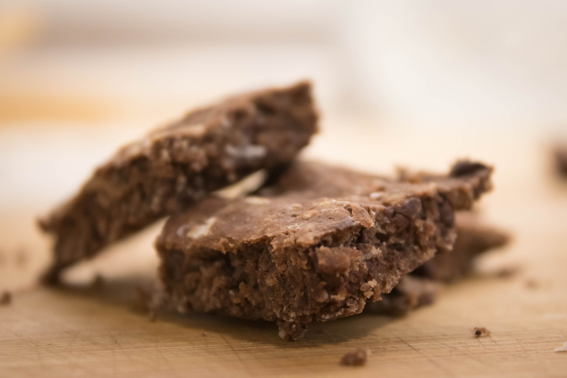 Chocolate oat bars on a wooden surface.