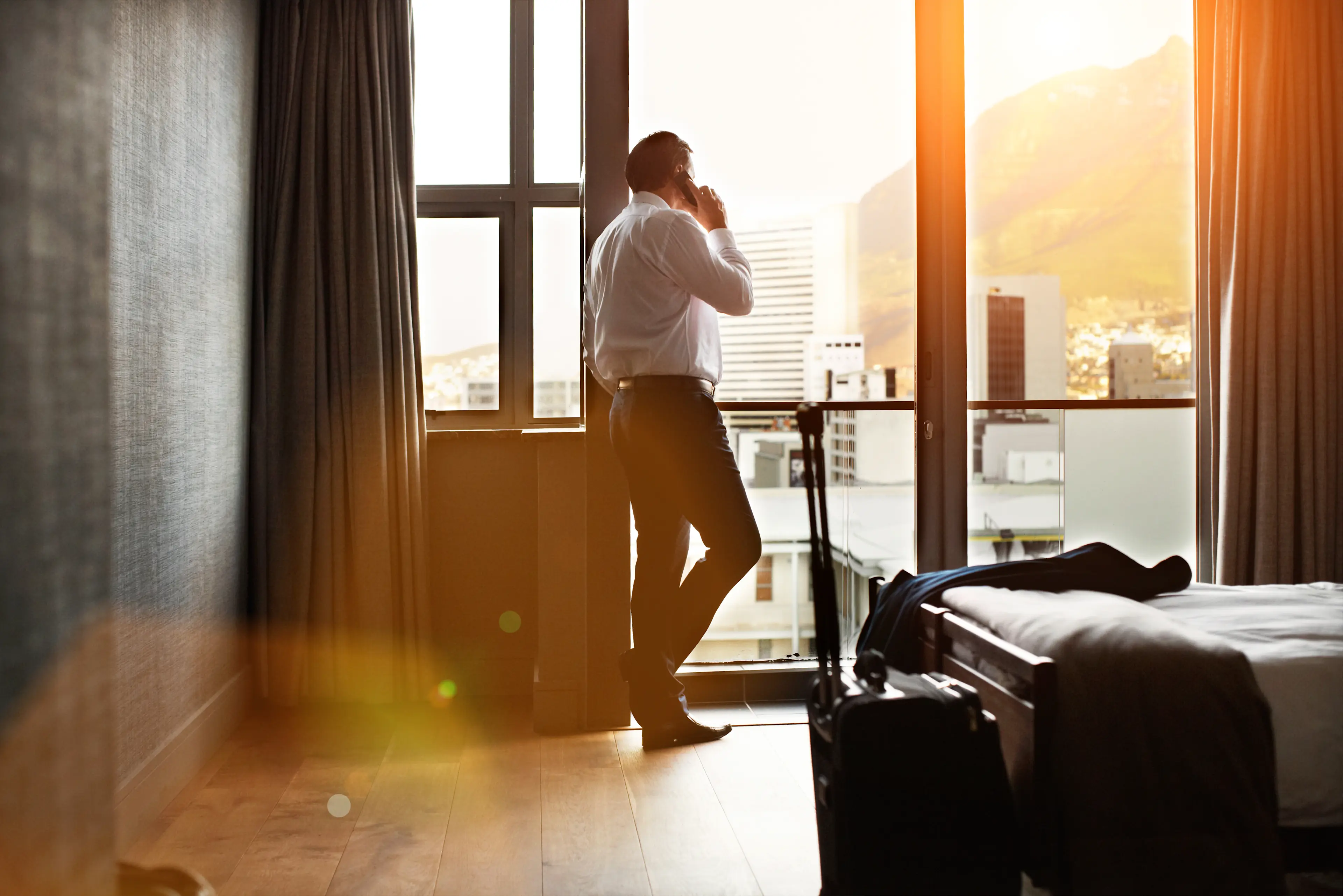 business man at hotel room, using his mobile phone