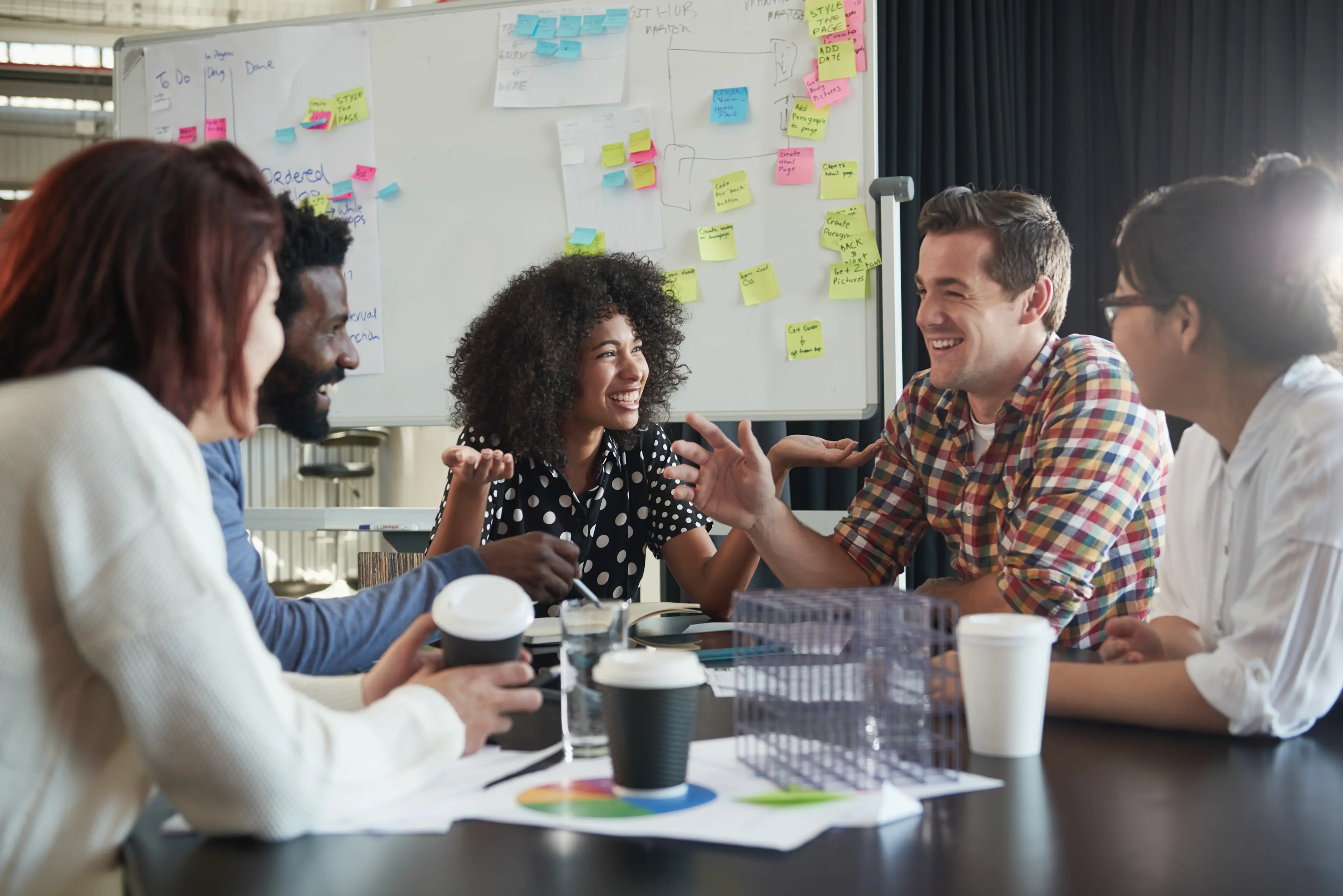 group of people happily working at a round table