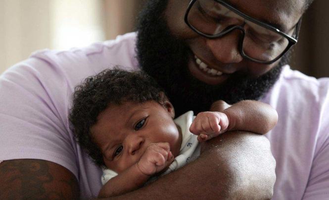 father holding baby