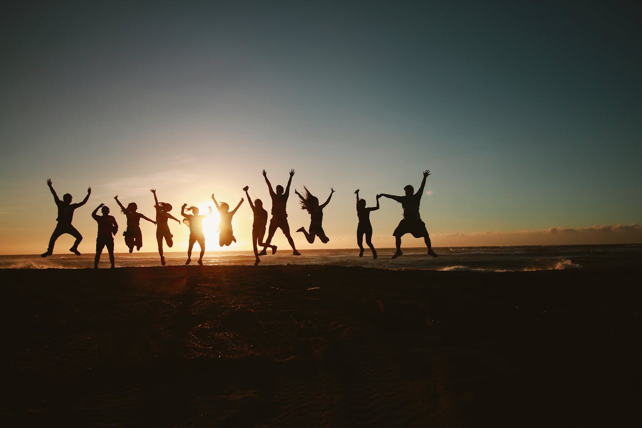 group-of-people-jumping-during-golden-time