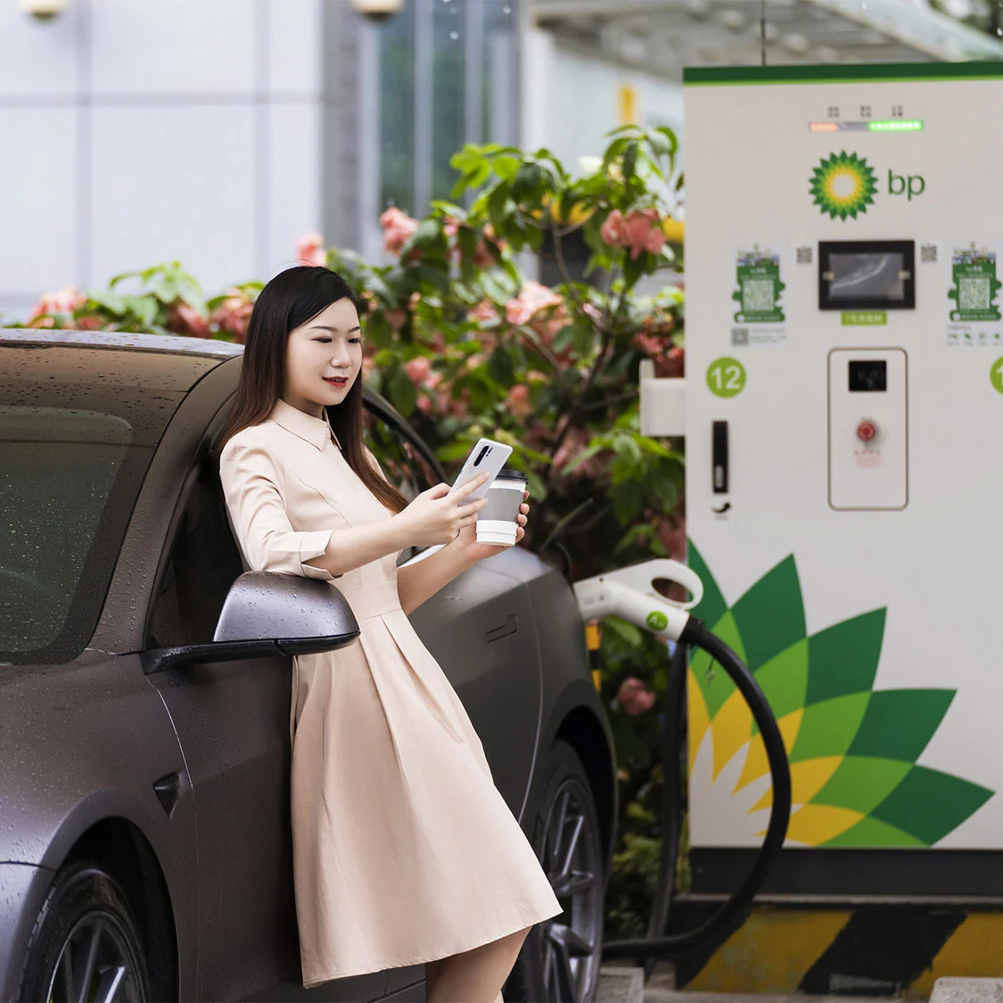 A customer chargers her EV in Guangdong province, China