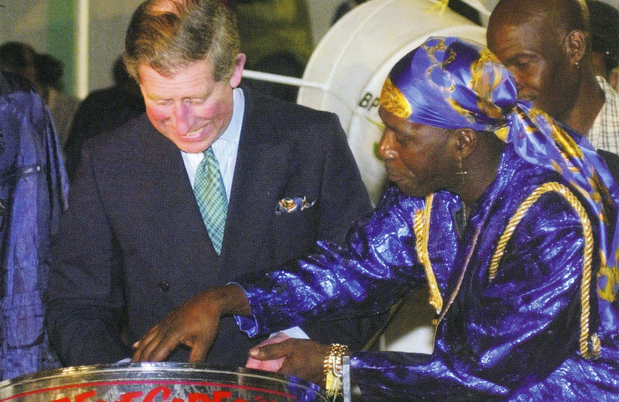Prince Charles tries the steel drums with the Renegades band in Trinidad and Tobago