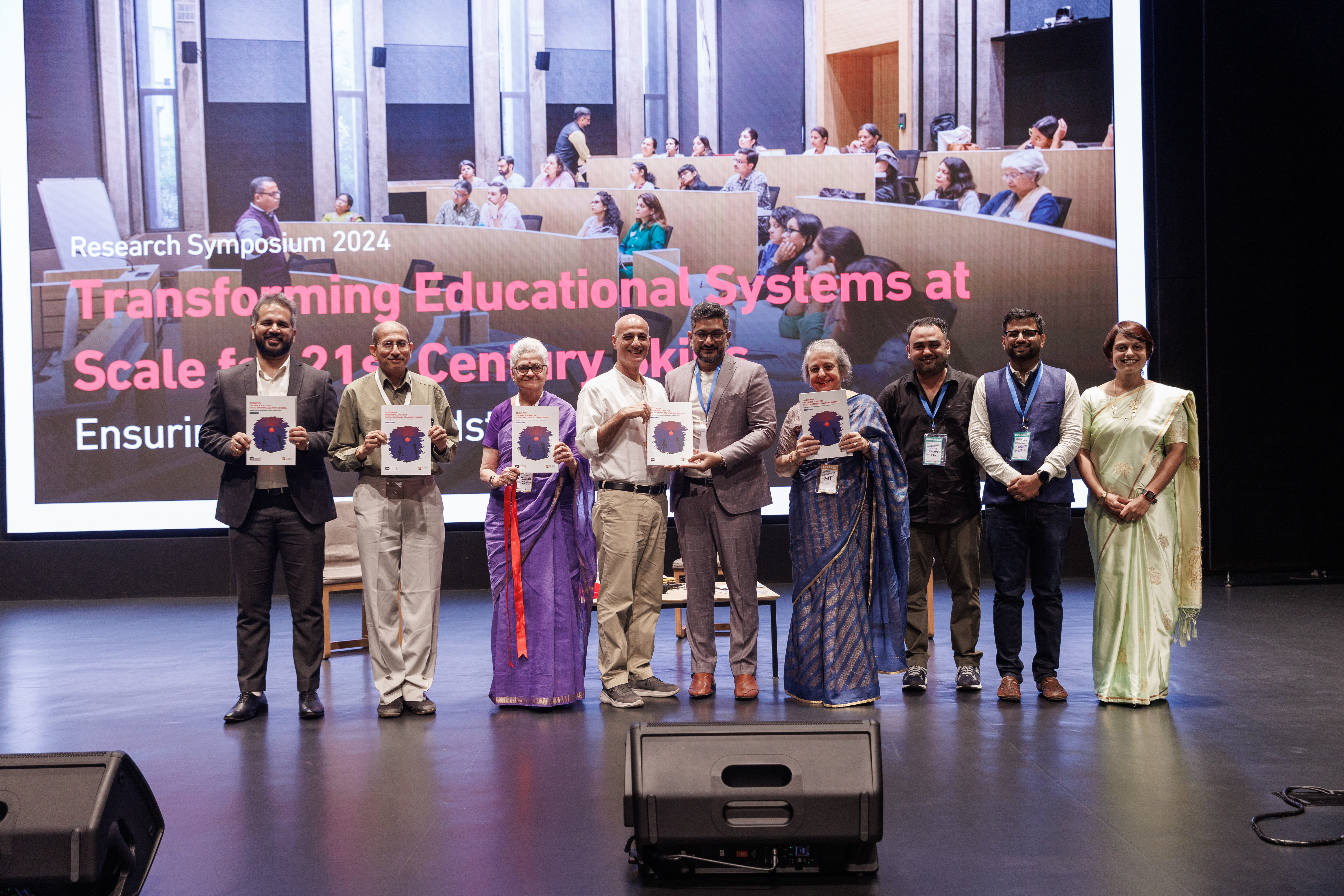 Madhukar Banuri and others at the stage of a 2024 research symposium