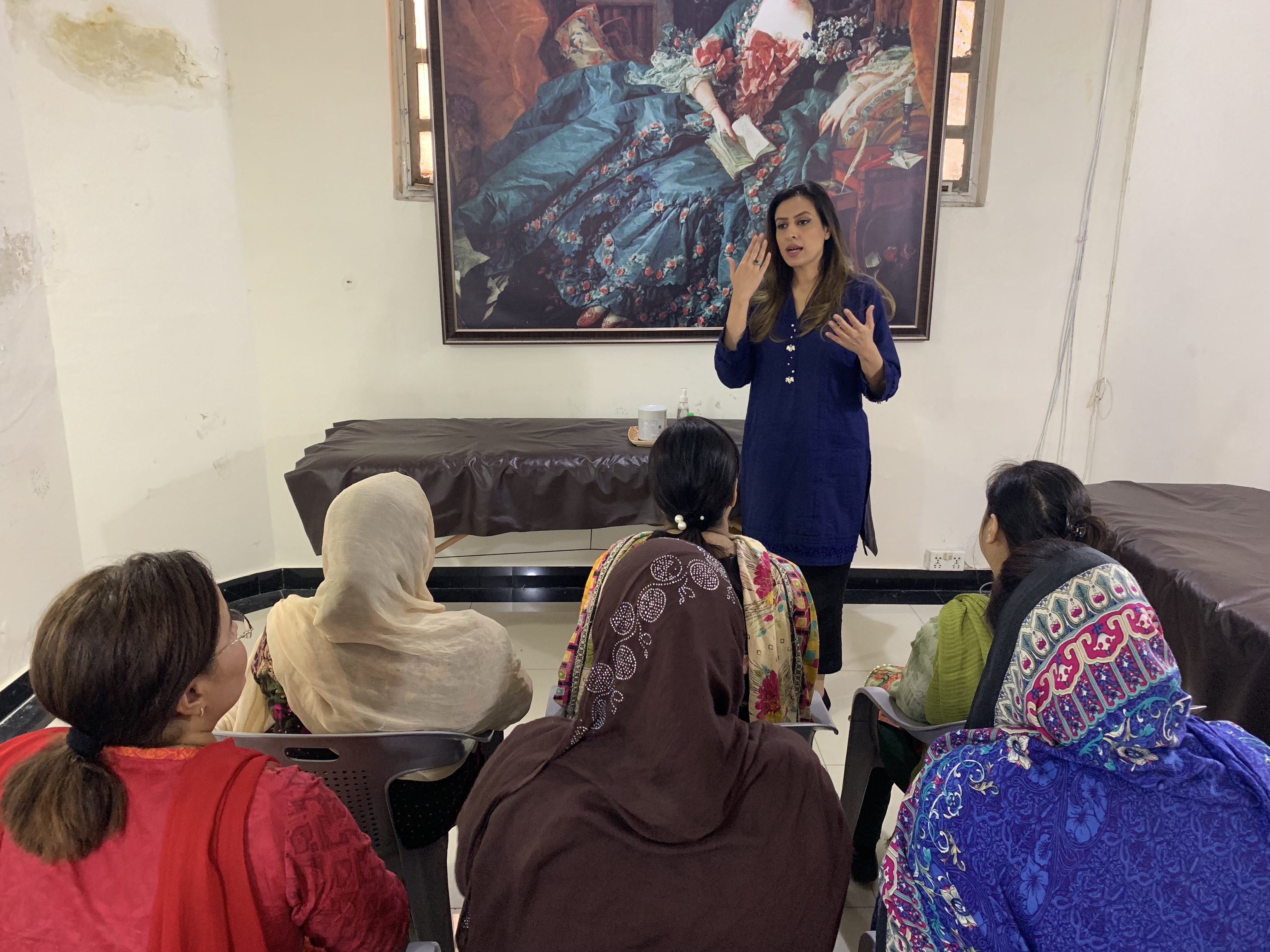 Beautician imparting a lesson to women
