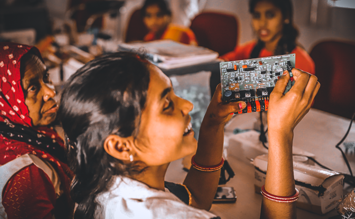 Young person handling a circuit board