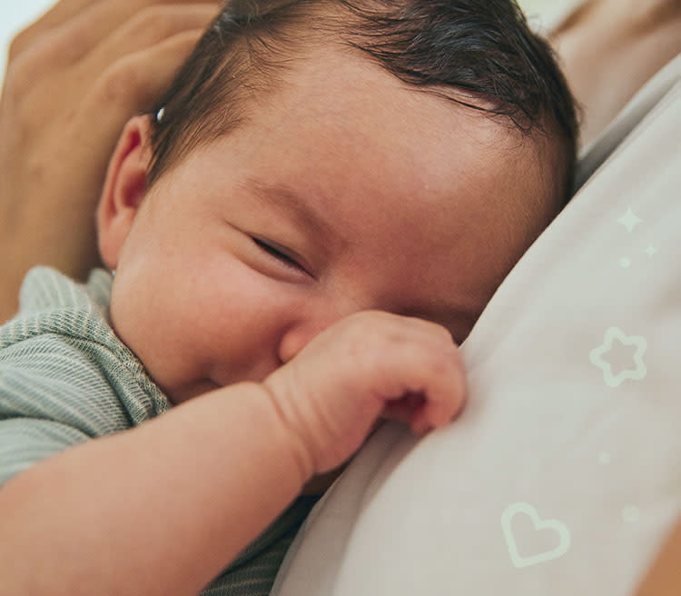 Smiling mother with baby in her arms