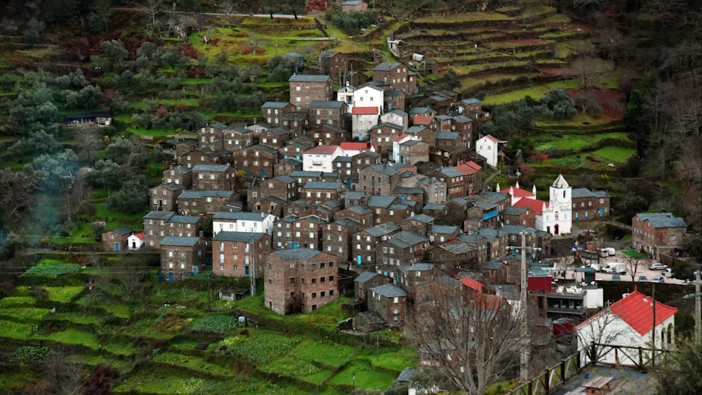 A schist-clad village tucked into the mountains, with winding lanes and quiet beauty.