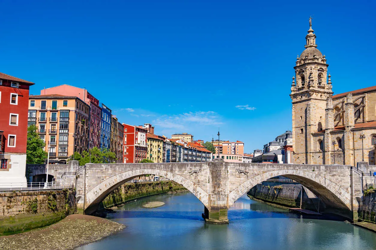 Bilbao's Nervión River flows past the historic San Antón Church and Biscay Bridge.