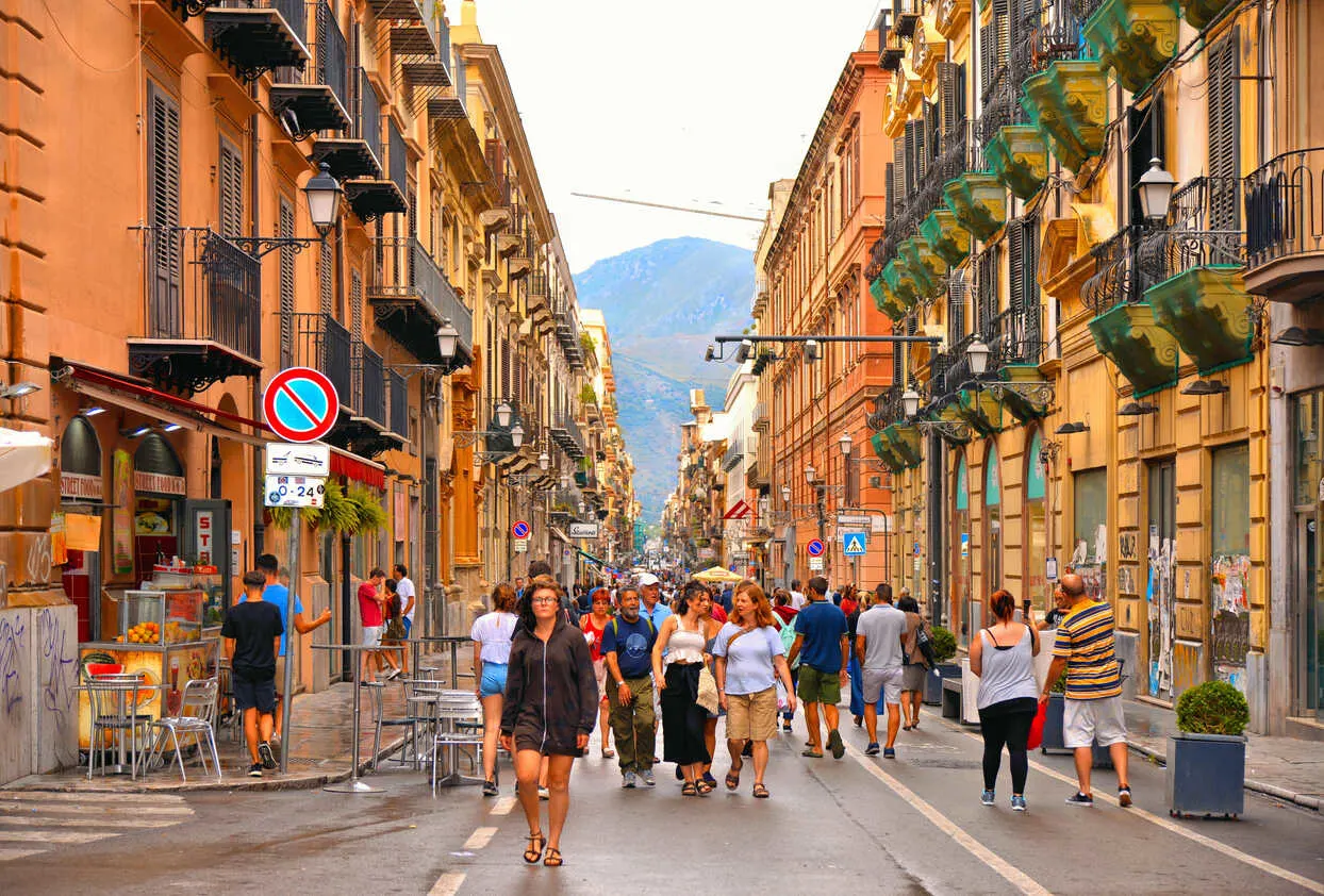 Everyday life unfolds on Palermo’s sun-warmed streets.