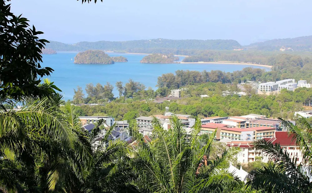 A scenic view of Ao Nang Bay in Krabi, where lush greenery meets the sea.