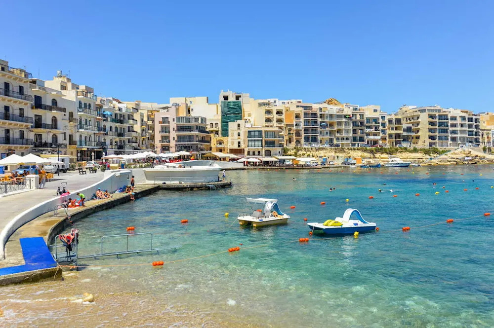 Marsalforn, a favorite expat spot in Gozo, blends village charm with seaside living.