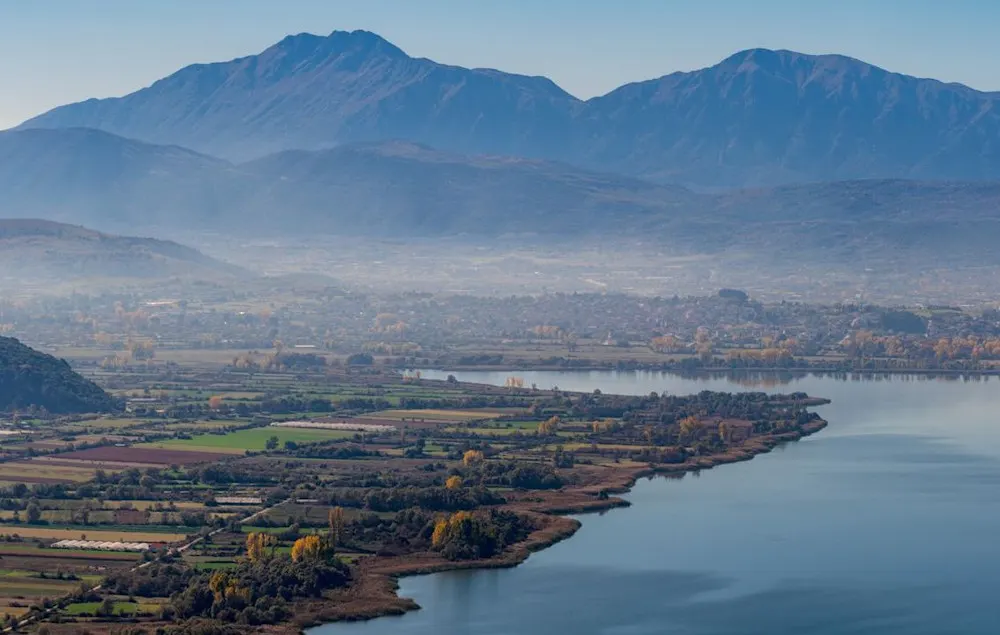 Rural landscape near Ioannina with rolling fields and mountain views.