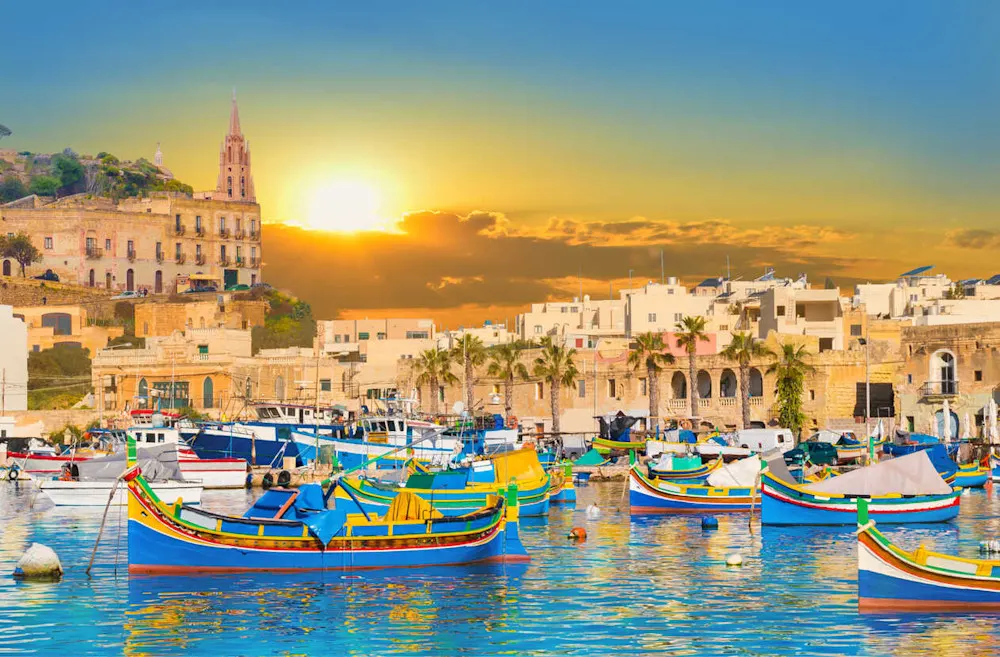Traditional luzzus line the harbor in this vibrant fishing village.