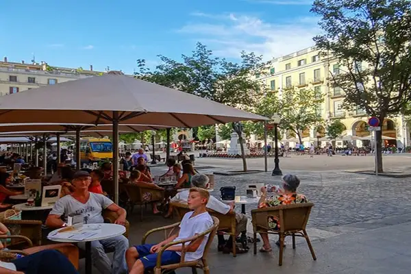 Bustling cafés line Girona’s historic Independence Square.