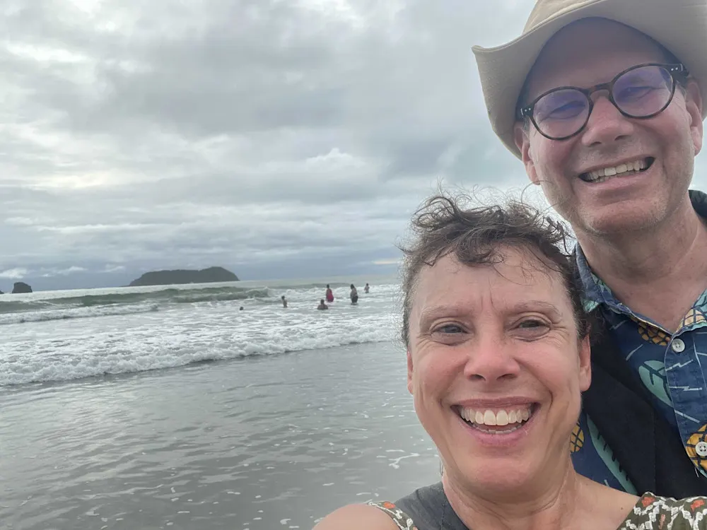 Embracing the elements on Playa Espadilla, where rain couldn’t dampen the beauty of Costa Rica’s coastline.