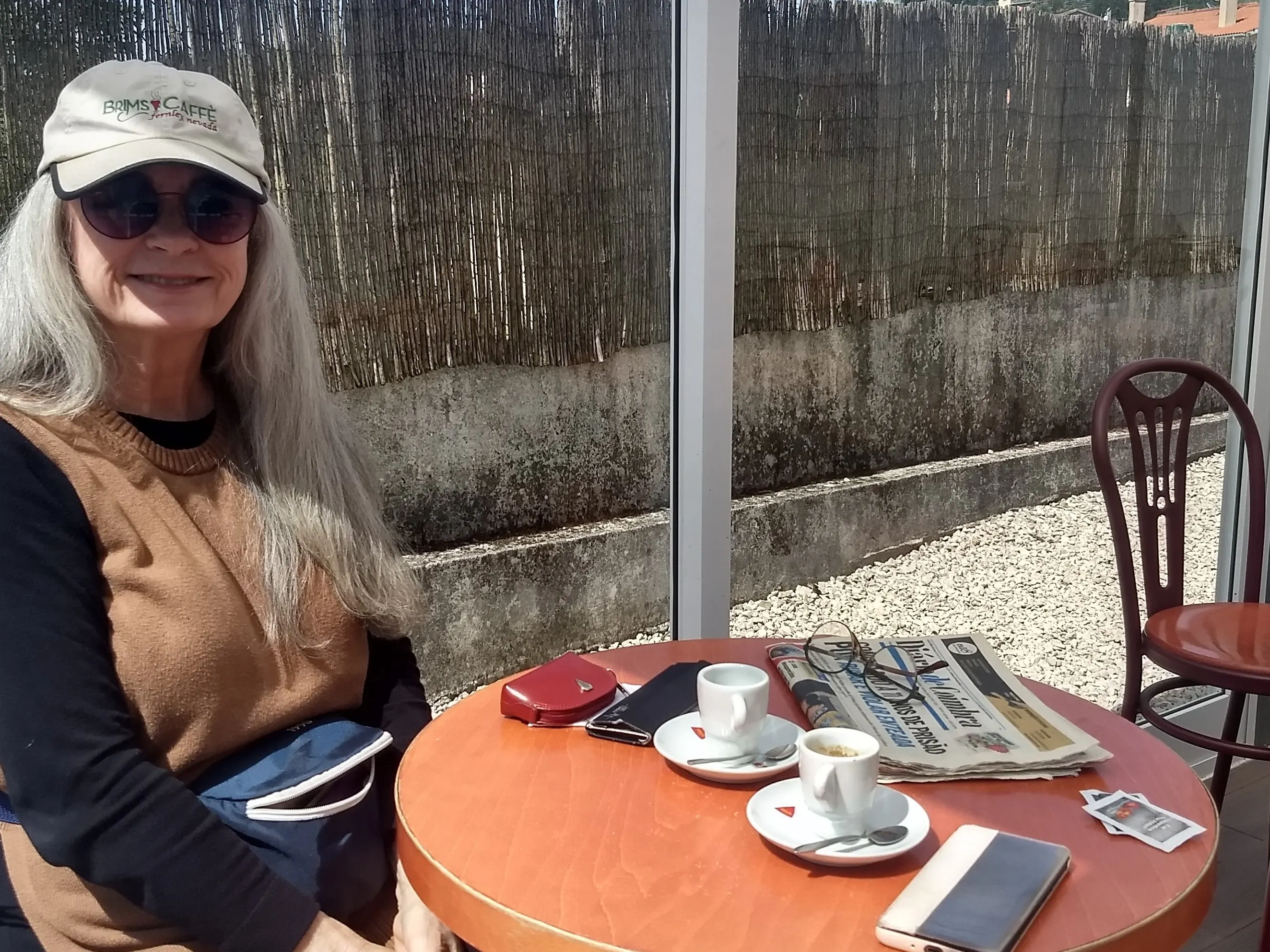 Tricia relaxing at a cozy café in Coimbra.