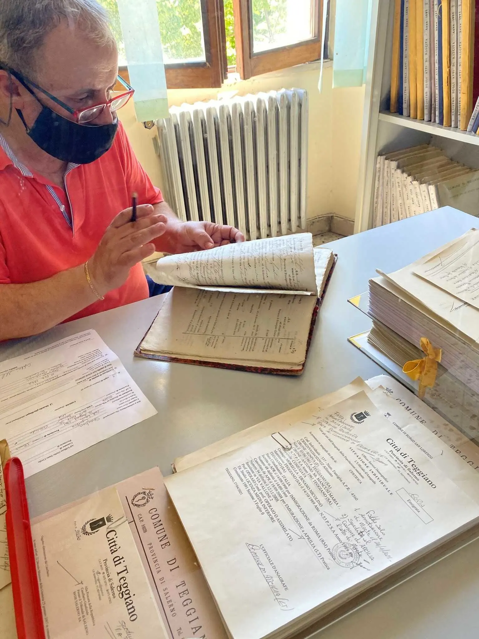 The clerk in Teggiano searches for Cindy's great-grandfather's birth certificate.