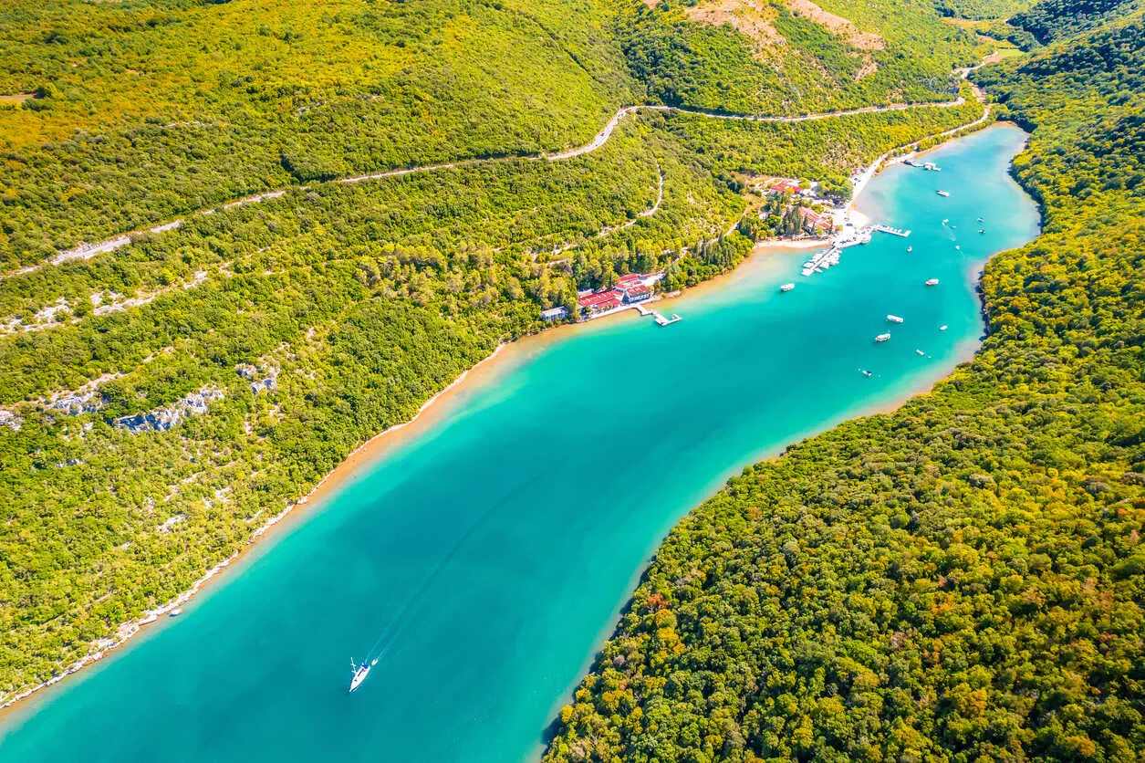 Aerial view of Lim Fjord’s turquoise waters and forested cliffs near Rovinj.