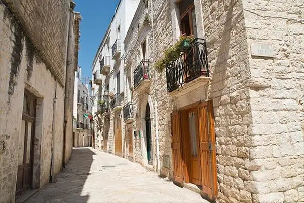 Pale limestone townhouses glow in the afternoon sun across the province of Puglia. © Milla1974/iStock.