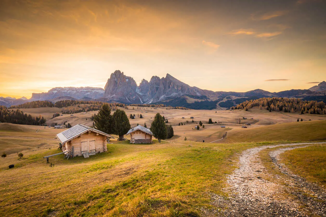 Golden sunset over Alpine meadows in the Italian Dolomites.