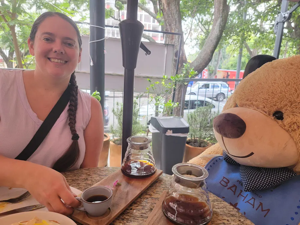 Amy shares a coffee with a café regular.