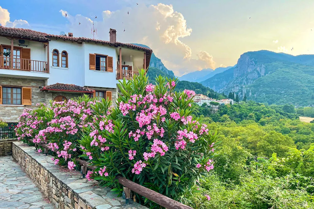 Traditional home in Litochoro, with blooming oleanders and Mount Olympus rising in the background.