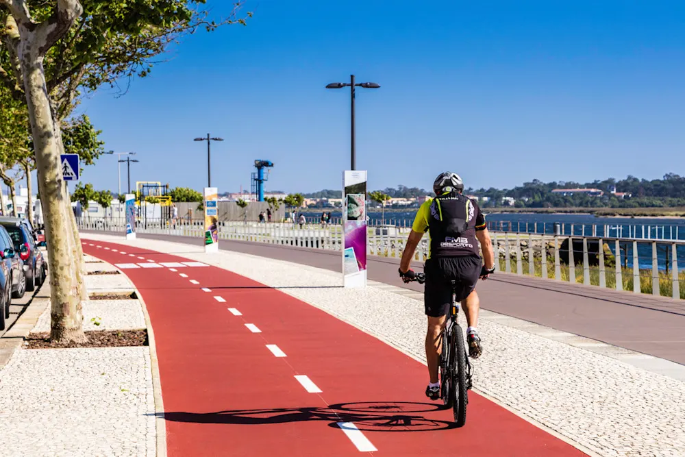 A cyclist enjoys the seaside promenade in peaceful, breezy Esposende.