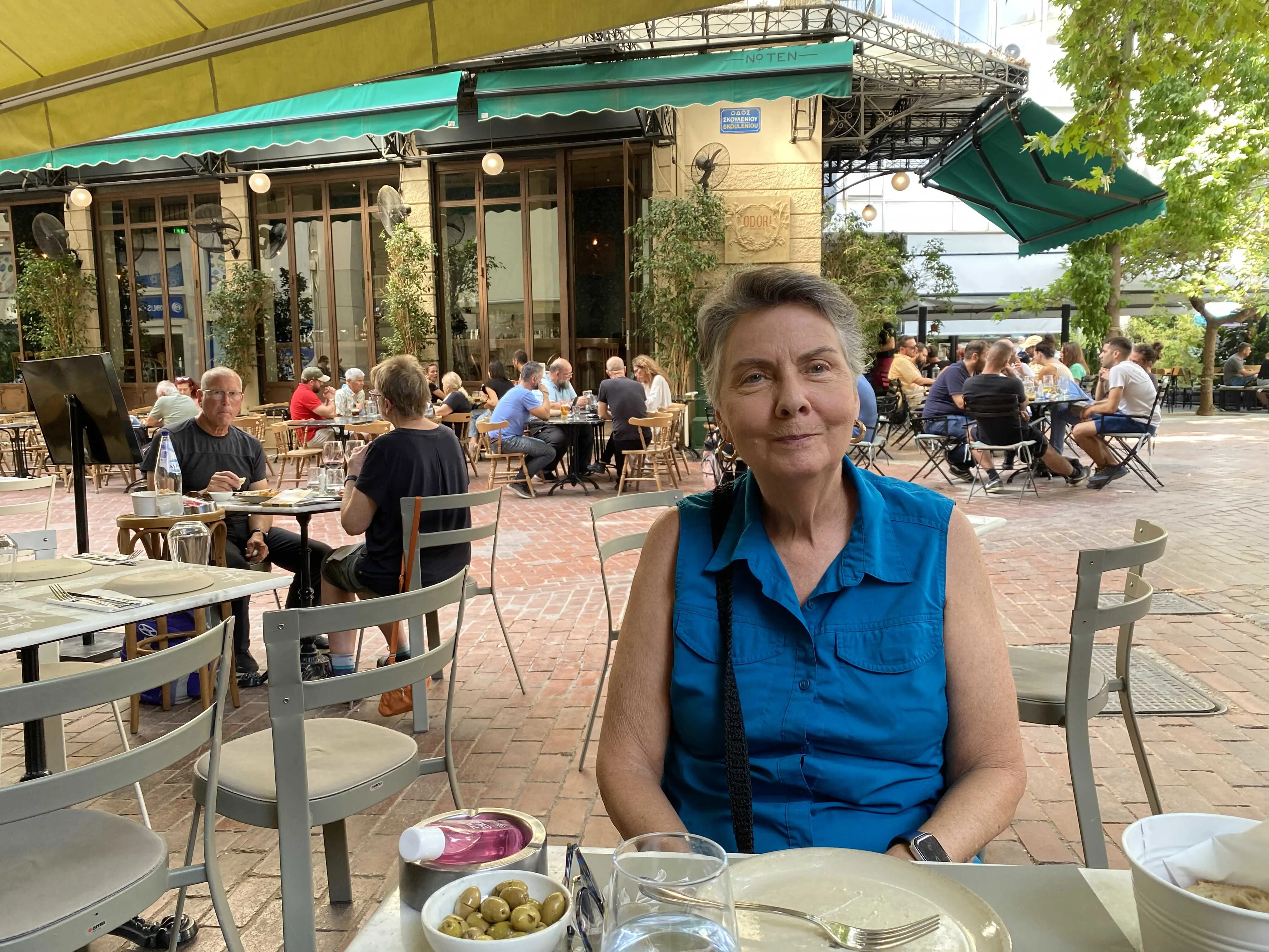 Rita at a charming café in Greece.