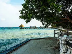 Expats on Caye Caulker enjoy crystal-clear waters, catching up with friends, and taking walks along soft white-sand beaches.