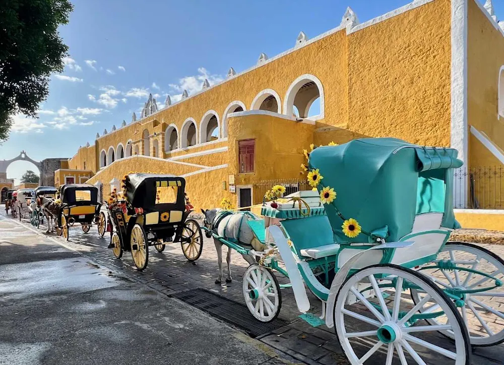 Horse-drawn carriages outside the Convento de San Antonio in Izamal.