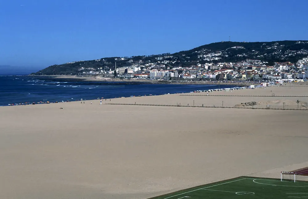 Portugal’s widest beach with golden sand and a historic clock tower.