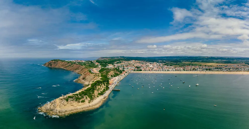 A calm, shell-shaped bay perfect for families and paddleboarding.