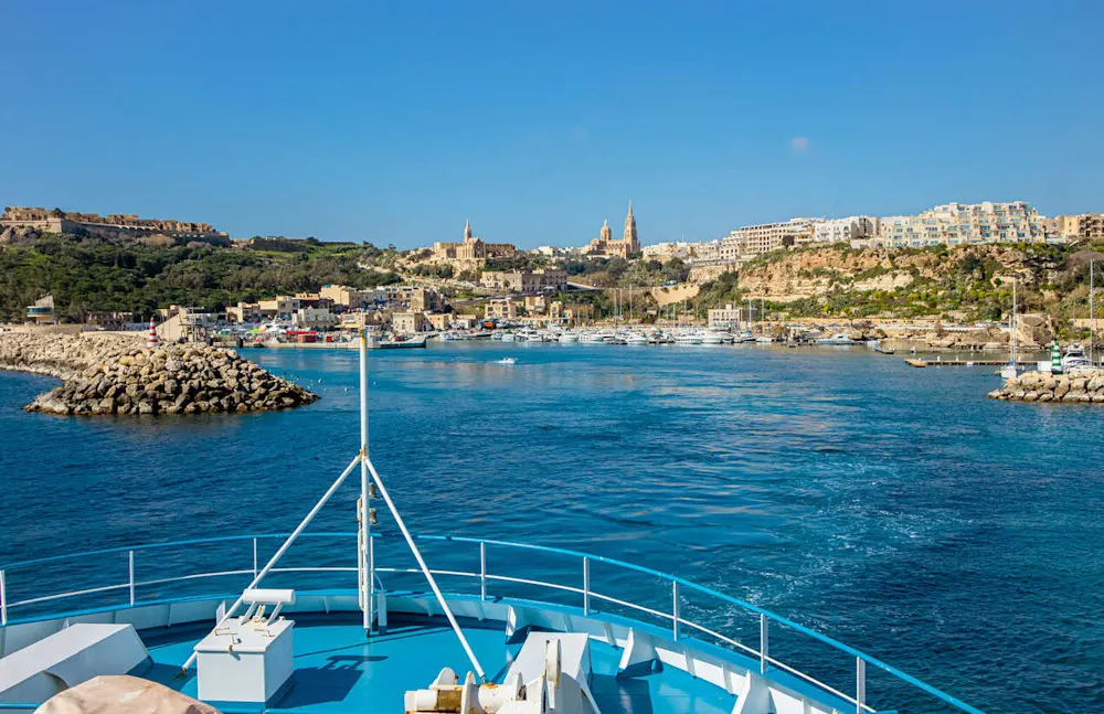 Mġarr Harbor: The gateway to Gozo, framed by fishing boats and village charm.