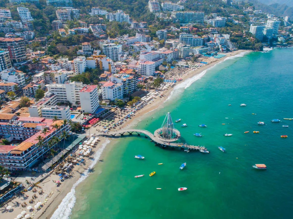 Playa Los Muertos, where the iconic pier and golden sands meet the lively energy of beachgoers and seaside fun.