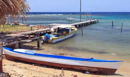 Reefs, jetties, palm fronds, and boats. The Caribbean dream is within grasp in Cabarete. ©iStock.com/VisionsbyAtlee