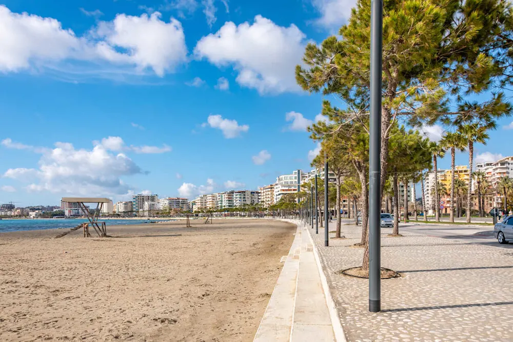 Palm-lined promenade and sparkling shoreline in vibrant Vlorë.