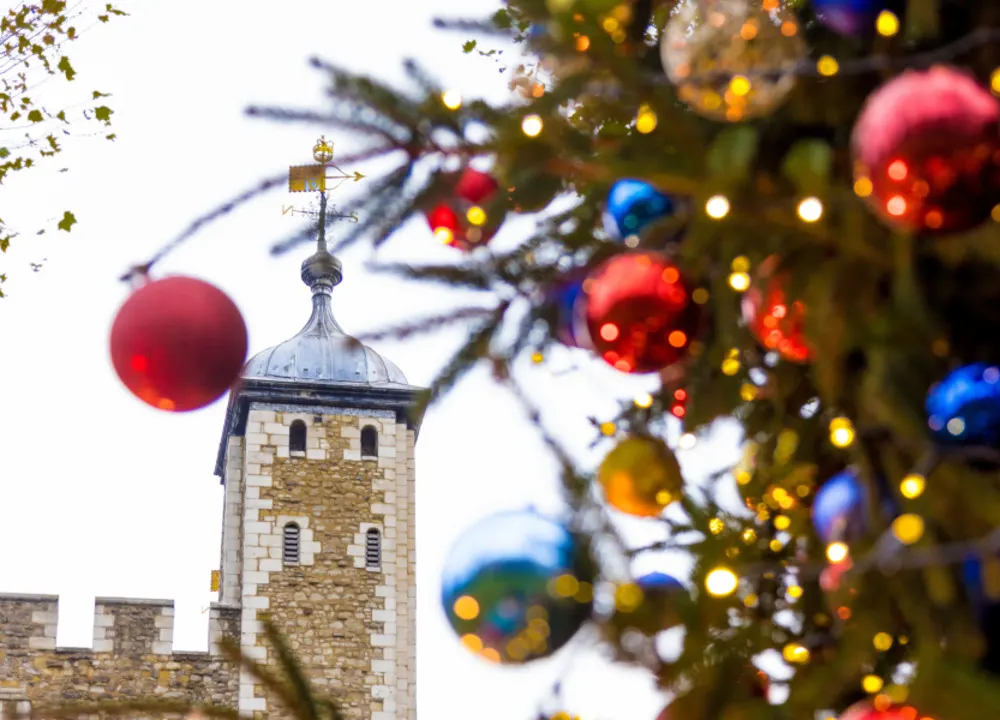 Festive decorations frame the historic Tower of London, bringing holiday cheer to a timeless landmark.