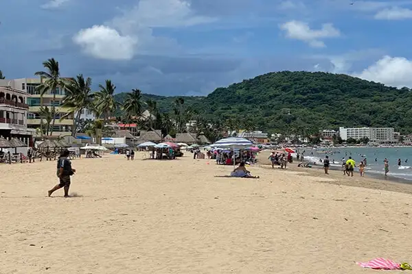 The beach on Rincón de Guayabitos is lined with simple hotels and condo buildings where two-bedroom units go for $350,000 and up.