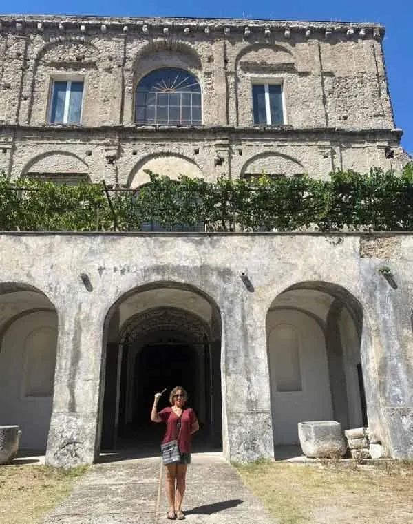 Cindy standing in front of the castle that bears her name in Salerno, Italy.