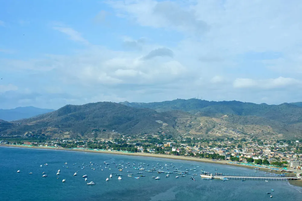 Colorful boats rest in Puerto López Bay.