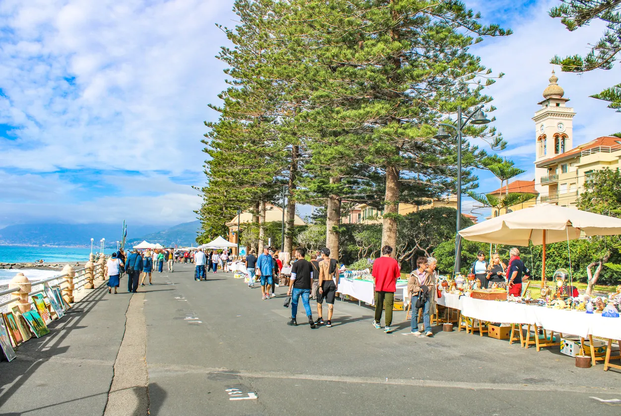 Shoppers enjoy the seaside flea market on Bordighera's Lungomare Argentina.