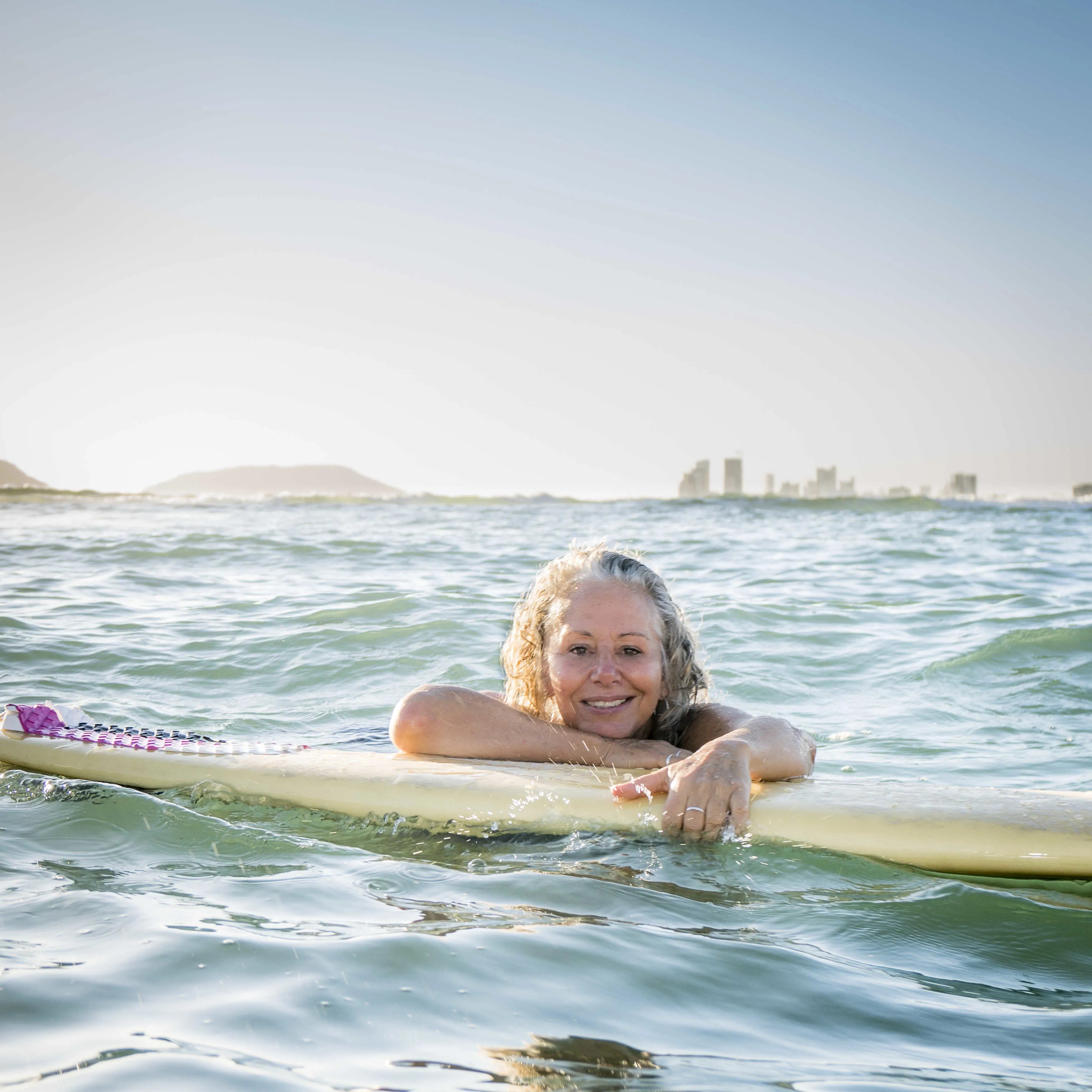 Janet enjoying the waves and sunshine in her tropical expat paradise.