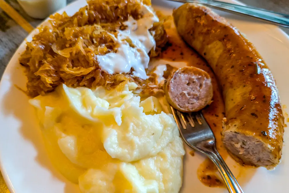 A classic Latvian meal of Rivel sausage with sauerkraut and mashed potatoes.