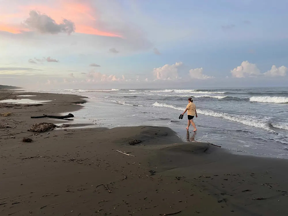 Strolling along the tranquil shores of Tortuguero at sunrise.