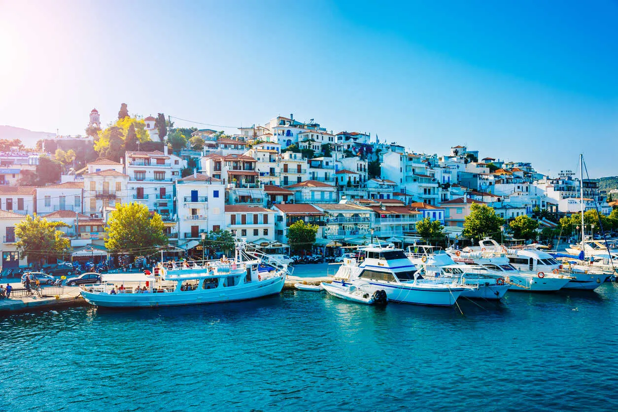 Charming Skiathos Town with white-washed buildings and serene harbor.