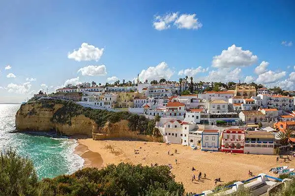 A view of nearby Carvoeiro, a vacation town that has retained its traditional fishing village charm. ©iStock.com/Antonel