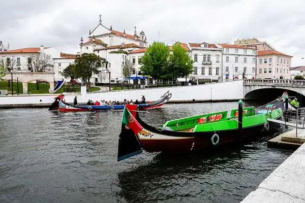 A brightly painted moliceiro boat waiting to take tourists on a cruise.